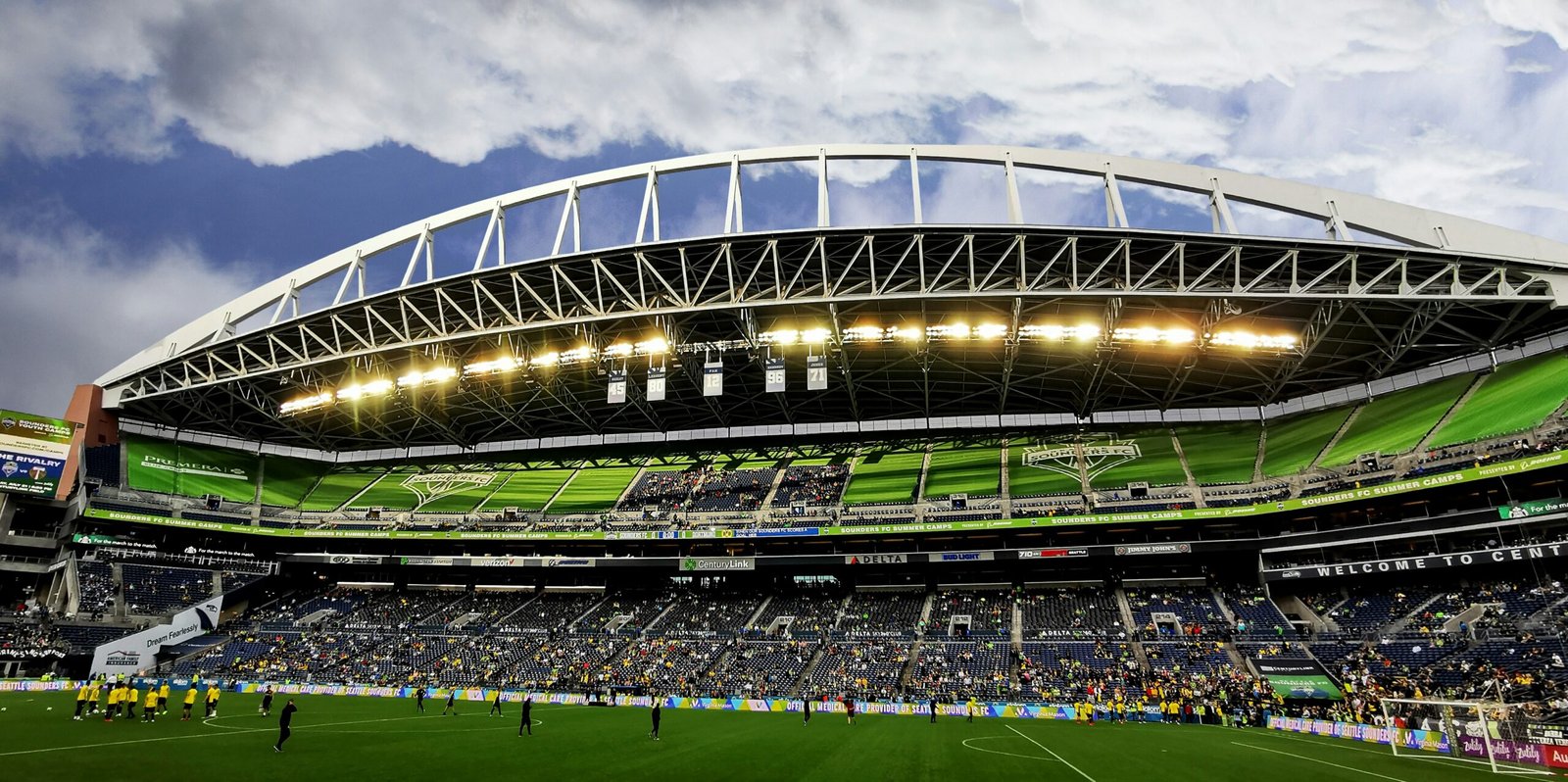 people watching soccer game during daytime